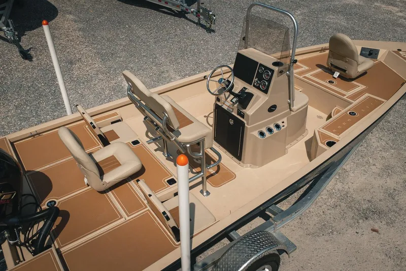 Slide: The Image of 2025 G3 Bay 19 GX boat on trailer, featuring beige interior and steering console. - 4