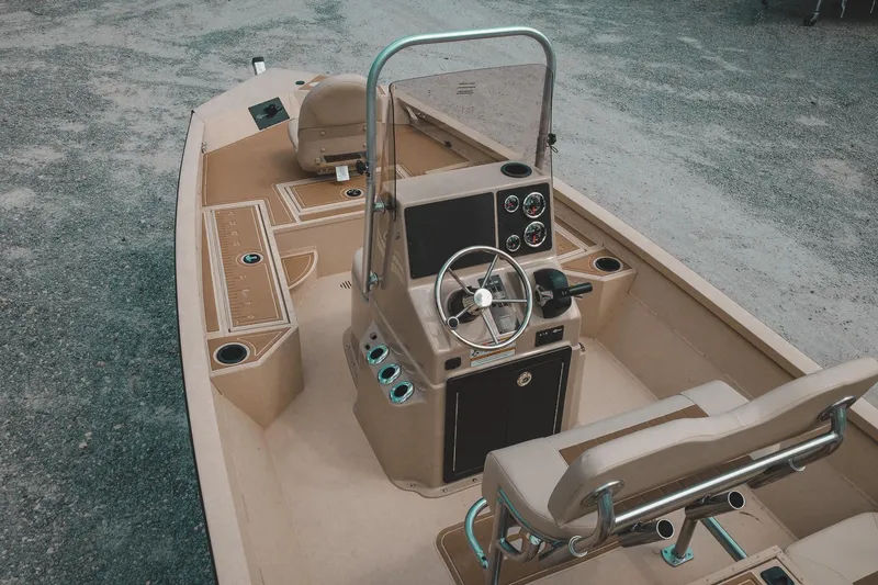 Slide: The Image of 2025 G3 Bay 19 GX boat interior with steering console and seating. - 5