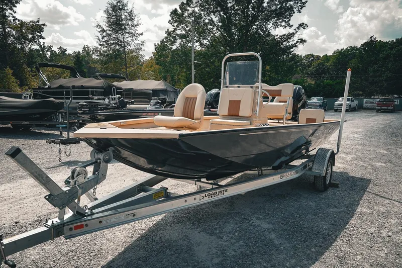 Slide: The Image of 2025 G3 Bay 19 GX boat on trailer in outdoor dealership setting. - 7