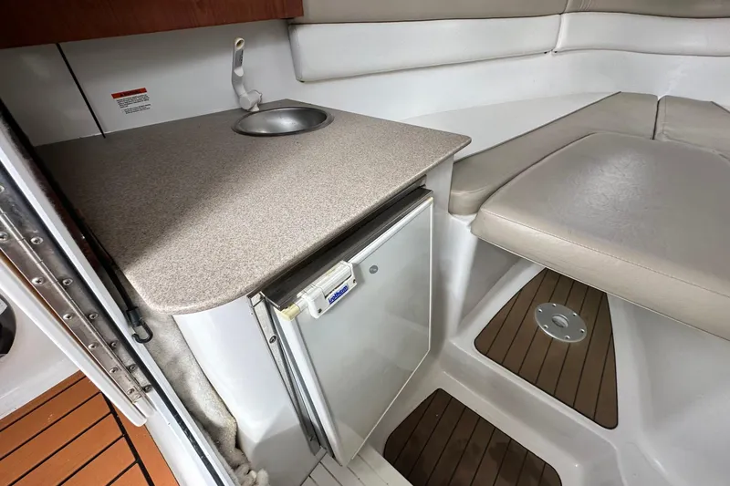 Slide: The Image of 2016 Sea Fox 256 Voyager cabin interior with sink, countertop, and seating area. - 6