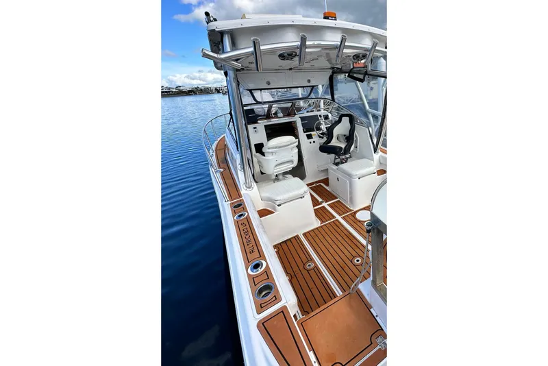 Slide: The Image of 2016 Sea Fox 256 Voyager boat interior with wooden deck and seating. - 8