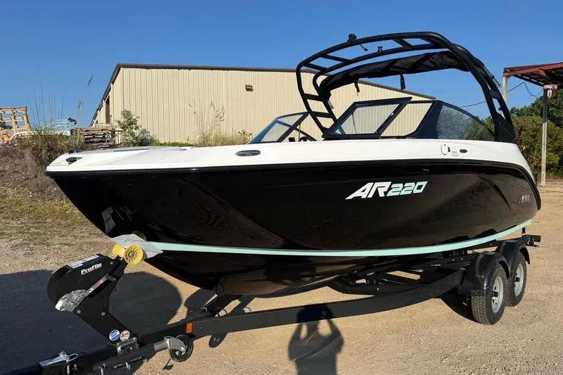Slide: The Image of 2026 Yamaha Boats AR220 on trailer, black and white design, parked outdoors. - 1
