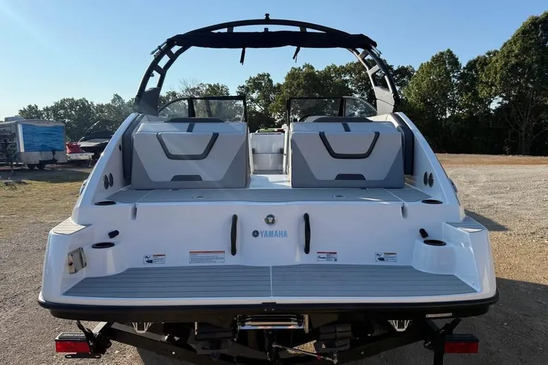 Slide: The Image of 2026 Yamaha Boats AR220, rear view, on land with trees in background. - 5