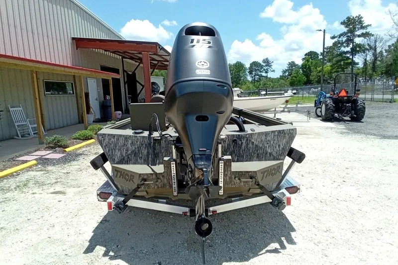 Slide: The Image of 2026 Thor 1900 Lake Hammer SC boat with powerful outboard motor, parked outdoors. - 16