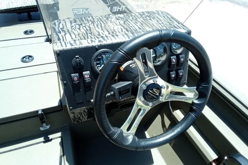 Slide: The Image of 2026 Thor 1900 Lake Hammer SC boat dashboard with steering wheel and control panel. - 20