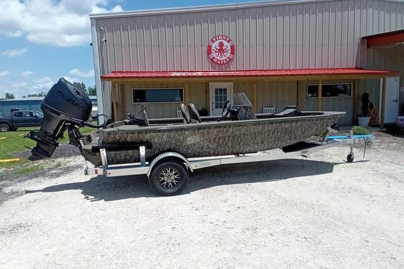 Slide: The Image of 2026 Thor 1900 Lake Hammer SC boat on trailer outside a building with red roof. - 3