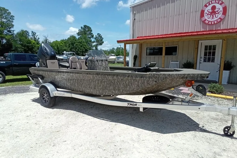 Slide: The Image of 2026 Thor 1900 Lake Hammer SC boat on trailer outside a building. - 4
