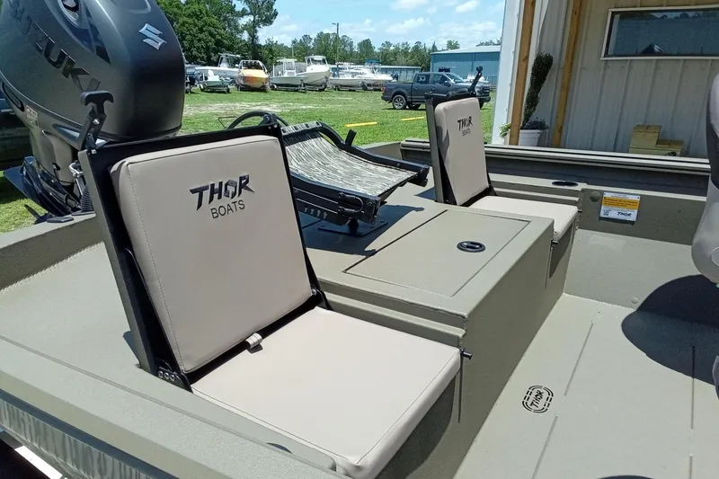 Slide: The Image of 2026 Thor 1900 Lake Hammer SC boat interior with branded seats and Suzuki engine. - 12