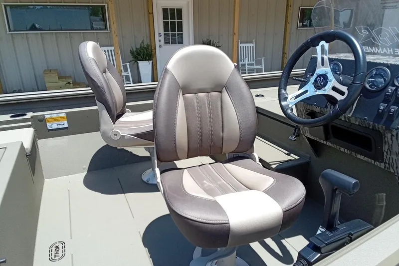 Slide: The Image of Interior of 2026 Thor 1900 Lake Hammer SC boat with modern seating and steering wheel. - 13