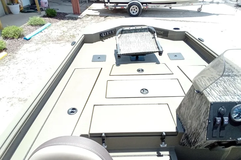 Slide: The Image of 2026 Thor 1900 Lake Hammer SC boat interior with storage compartments and control panel. - 22