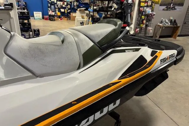 Slide: The Image of 2020 Sea-Doo FISH PRO jet ski in showroom, featuring sleek design and comfortable seating. - 8