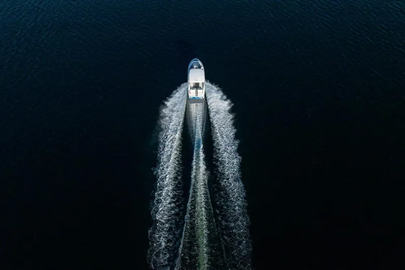 Slide: The Image of Aerial view of 2026 Regal LS9 boat cruising on dark water. - 5