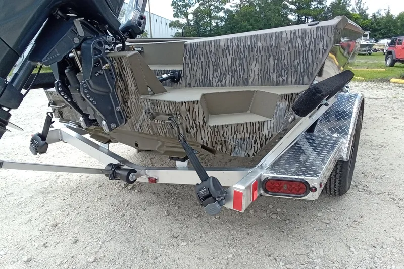 Slide: The Image of 2026 Thor 1754 Timber Hammer boat on trailer, featuring camouflage design and robust motor. - 15