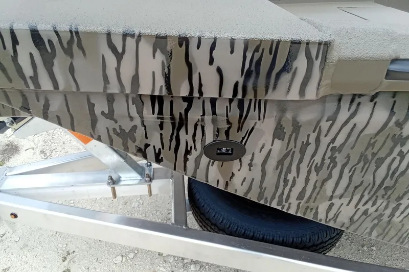 Slide: The Image of Camouflage-patterned 2026 Thor 1754 Timber Hammer boat on a trailer. - 8