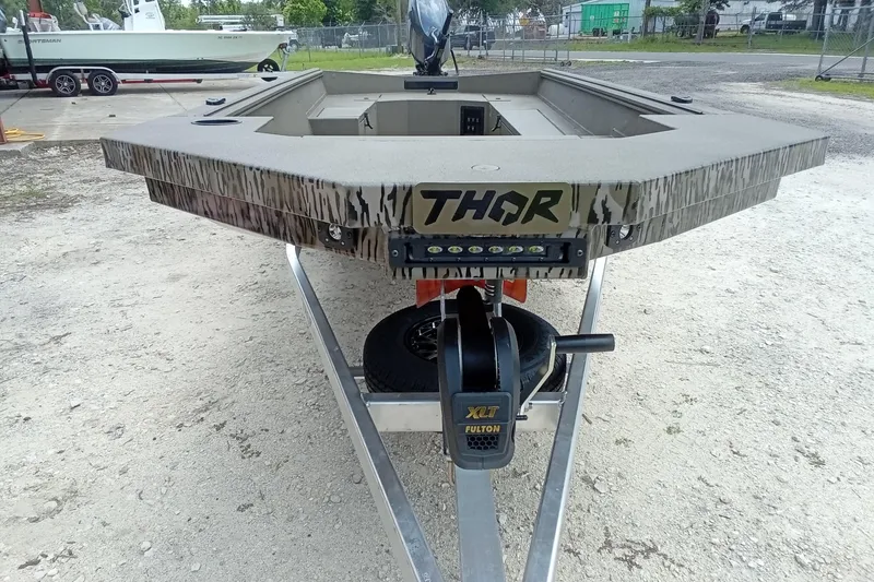 Slide: The Image of 2026 Thor 1754 Timber Hammer boat on trailer, featuring camo design and Fulton XLT winch. - 9