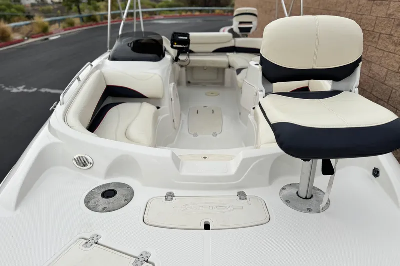 Slide: The Image of 2014 Tahoe 215 boat interior with white seating and fishing chair. - 10