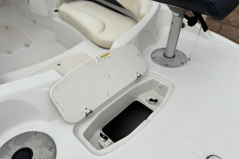 Slide: The Image of 2014 Tahoe 215 boat interior with open storage compartment and seating. - 12