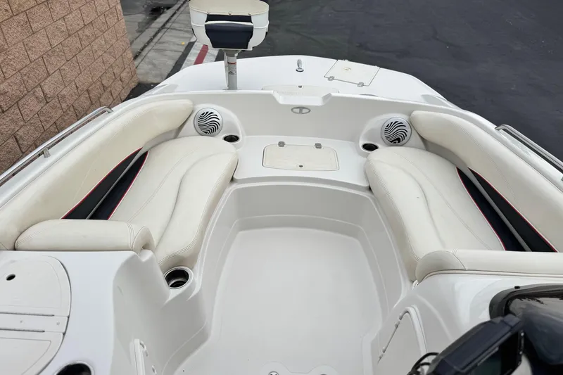 Slide: The Image of 2014 Tahoe 215 boat interior with white seating and speakers. - 13