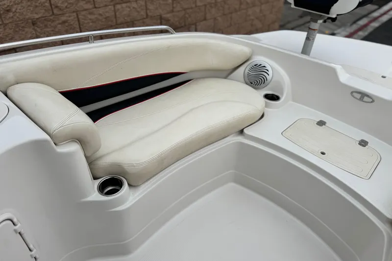Slide: The Image of 2014 Tahoe 215 boat interior with white seating and cup holders. - 14