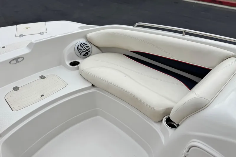 Slide: The Image of 2014 Tahoe 215 boat interior with white seating and speaker detail. - 15