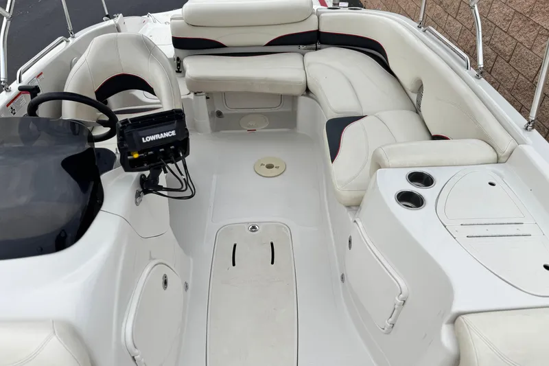 Slide: The Image of 2014 Tahoe 215 boat interior with white seating and Lowrance navigation system. - 17