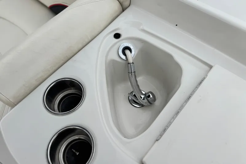 Slide: The Image of 2014 Tahoe 215 boat interior with sink and cup holders. - 19
