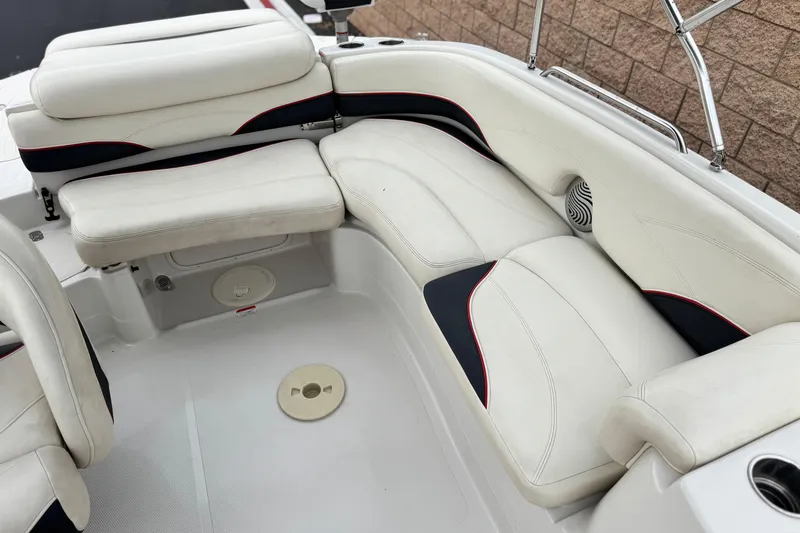 Slide: The Image of 2014 Tahoe 215 boat interior with white cushioned seating and speaker. - 22