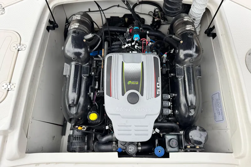 Slide: The Image of Engine compartment of a 2014 Tahoe 215 boat featuring a MerCruiser 5.0 MPI engine. - 24
