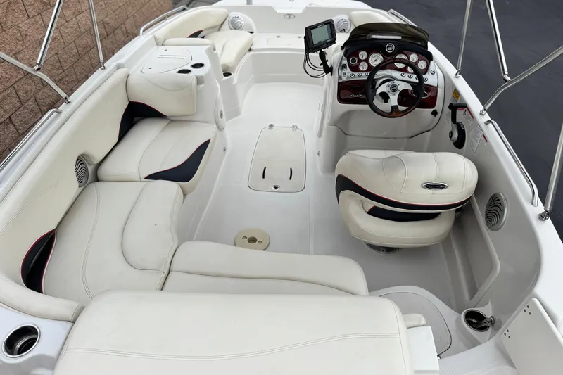 Slide: The Image of 2014 Tahoe 215 boat interior with white seating and modern dashboard. - 25