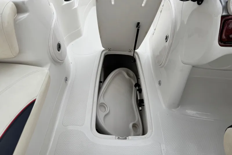 Slide: The Image of 2014 Tahoe 215 boat interior storage compartment with open hatch. - 26