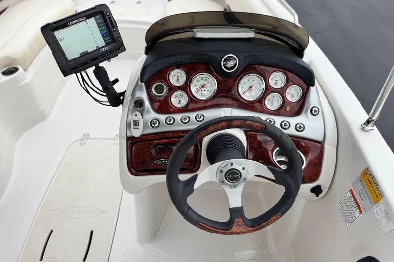 Slide: The Image of Steering console of 2014 Tahoe 215 boat with gauges and Lowrance display. - 28