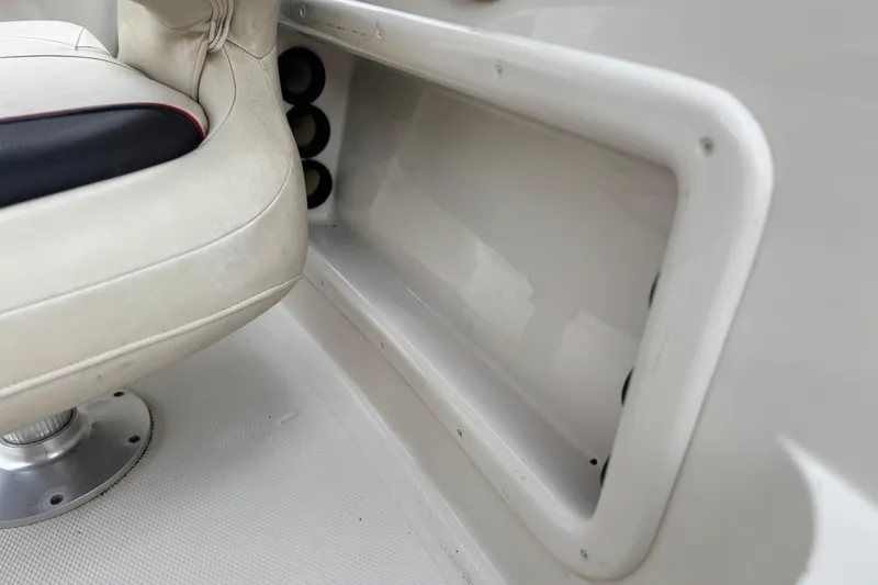 Slide: The Image of 2014 Tahoe 215 boat interior with white seating and storage compartment. - 31