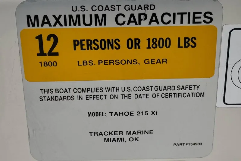 Slide: The Image of 2014 Tahoe 215 boat capacity label, 12 persons or 1800 lbs, U.S. Coast Guard compliant. - 33