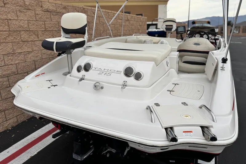 Slide: The Image of 2014 Tahoe 215 boat, white exterior, rear view with seating and controls. - 6