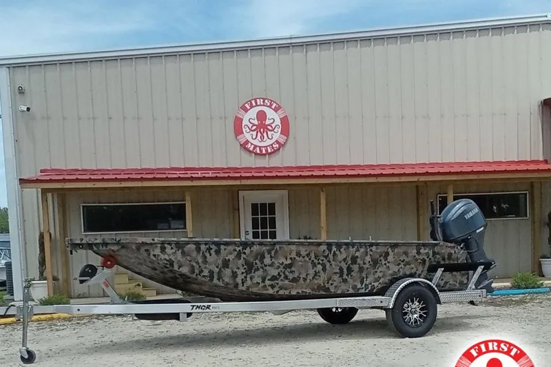 The Image of 2026 Thor 1754 Timber Hammer boat on trailer, camo design, outside First Mates building. - 1