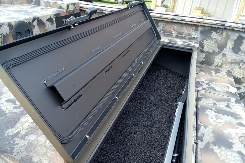 Slide: The Image of Open storage compartment in 2026 Thor 1754 Timber Hammer boat with camouflage design. - 11