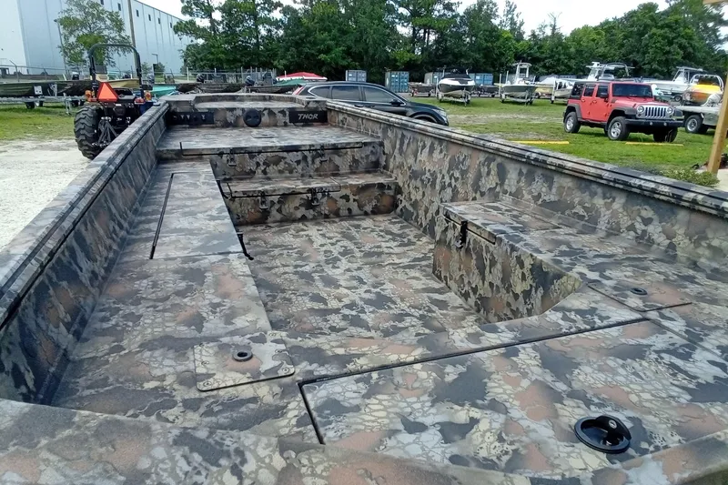 Slide: The Image of Camouflage-patterned 2026 Thor 1754 Timber Hammer boat in outdoor setting. - 16