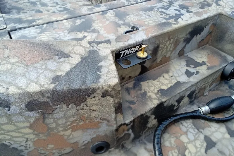 Slide: The Image of Camouflage-patterned Thor 1754 Timber Hammer boat detail, 2026 model, featuring rugged design elements. - 18