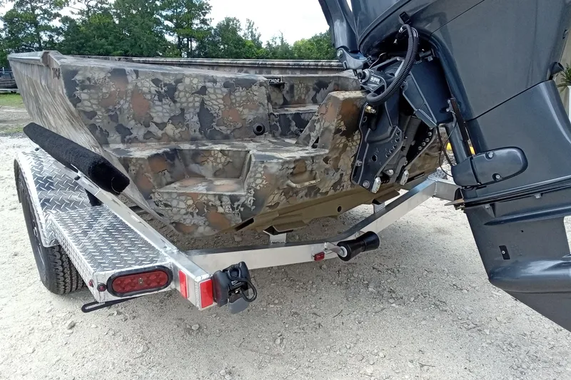 Slide: The Image of 2026 Thor 1754 Timber Hammer boat on trailer, featuring camouflage design and powerful outboard motor. - 19