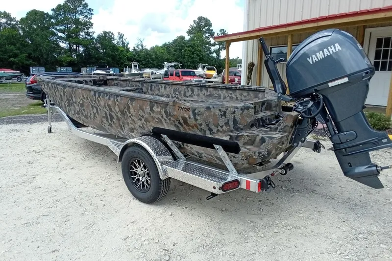 Slide: The Image of Camouflage-patterned 2026 Thor 1754 Timber Hammer boat with Yamaha motor on a trailer. - 20