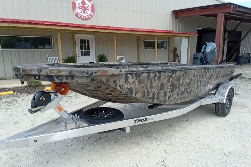 Slide: The Image of 2026 Thor 1754 Timber Hammer boat with camouflage design on a trailer. - 3