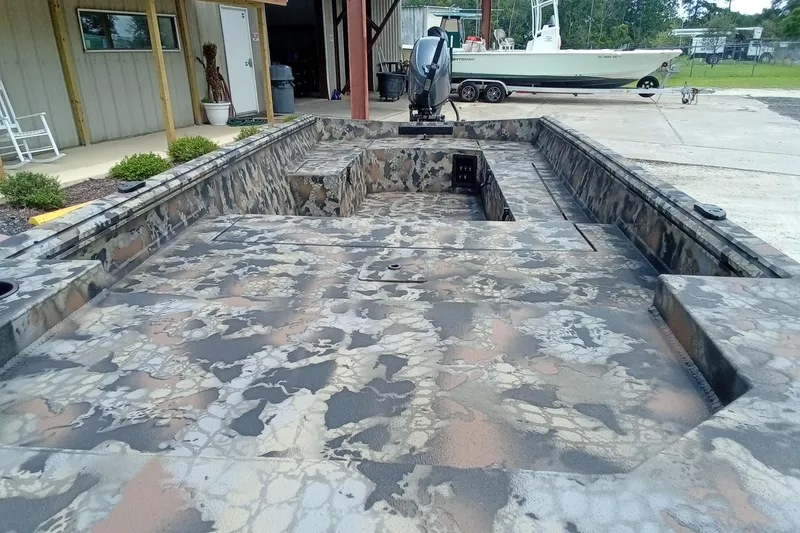 Slide: The Image of Camouflage-patterned Thor 1754 Timber Hammer boat, 2026 model, parked outdoors near a building. - 6