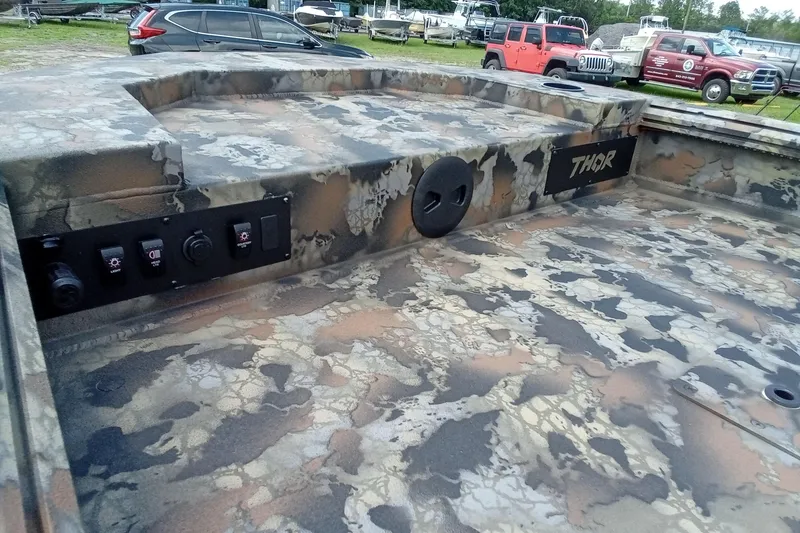 Slide: The Image of Camouflage-patterned 2026 Thor 1754 Timber Hammer boat interior with control panel. - 9
