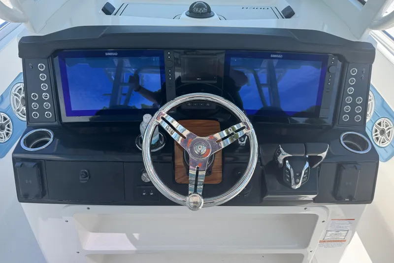 Slide: The Image of 2026 Robalo R300 Center Console dashboard with dual Simrad displays and modern controls. - 10