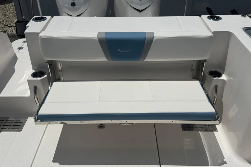 Slide: The Image of 2026 Robalo R300 Center Console boat with foldable seating and cup holders. - 12