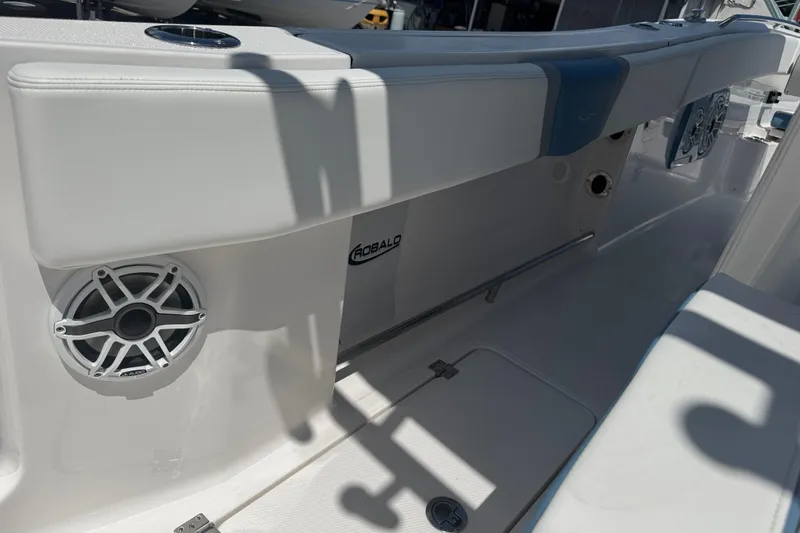 Slide: The Image of 2026 Robalo R300 Center Console boat interior with speaker and seating detail. - 14
