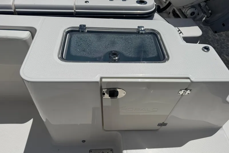 Slide: The Image of 2026 Robalo R300 Center Console boat with livewell and storage compartment. - 15