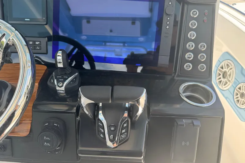 Slide: The Image of 2026 Robalo R300 Center Console boat dashboard with modern controls and touchscreen display. - 19