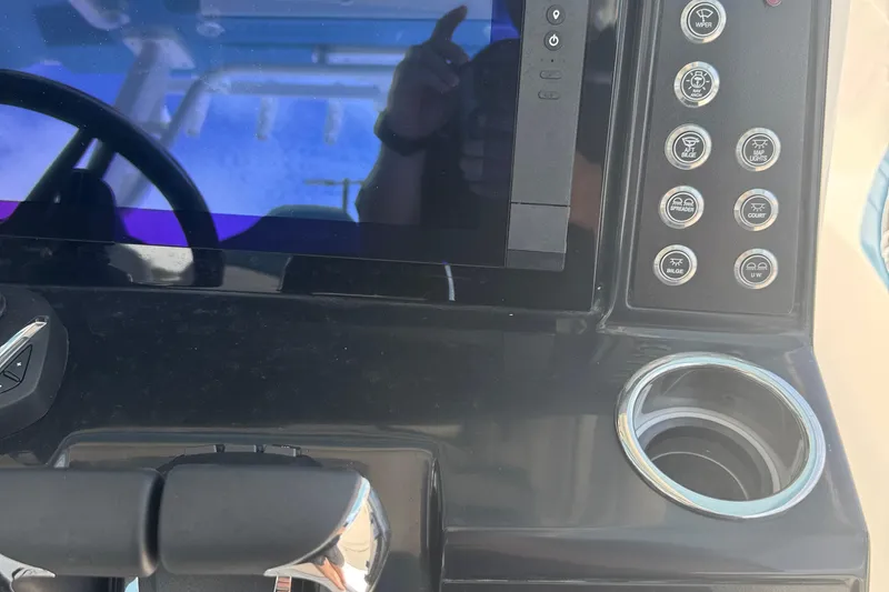 Slide: The Image of 2026 Robalo R300 Center Console dashboard with control panel and cup holder. - 20