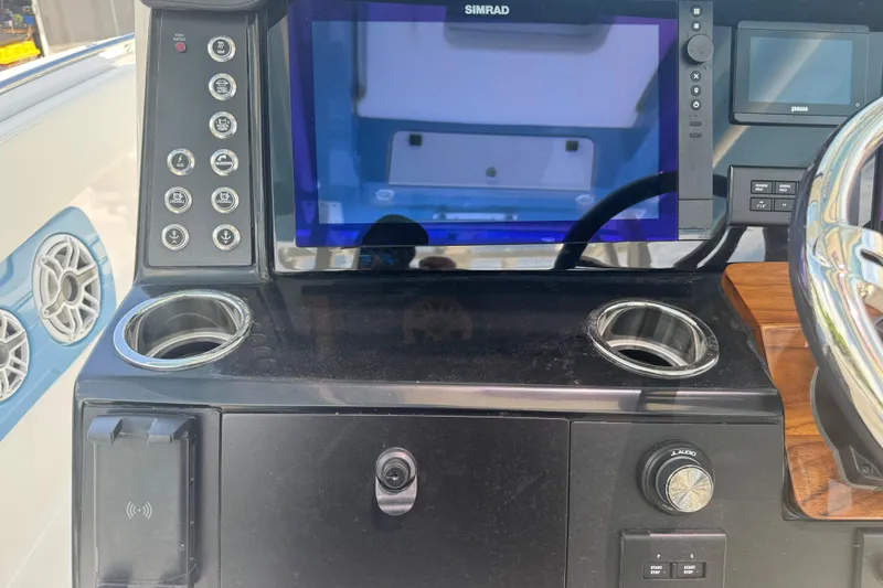 Slide: The Image of 2026 Robalo R300 Center Console dashboard with Simrad display and control panel. - 23